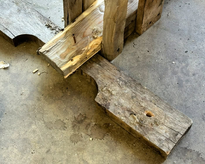 Drilled wood base support attached to a DIY Halloween pallet fence.